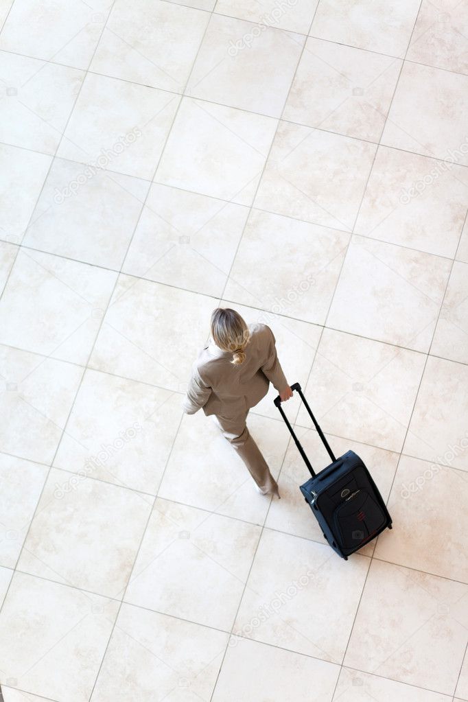Overhead view of young businesswoman walking at airport