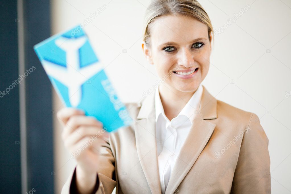 Attractive young businesswoman holding air ticket