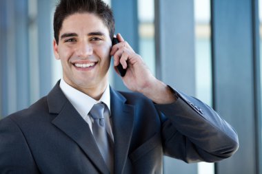 cep telefonuyla konuşurken mutlu başarılı genç iş adamı