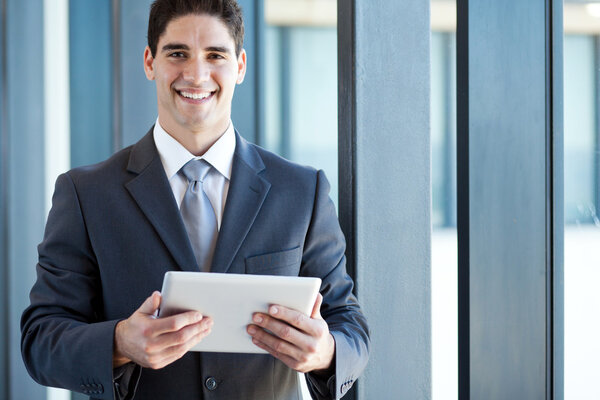 Young businessman with tablet computer in office