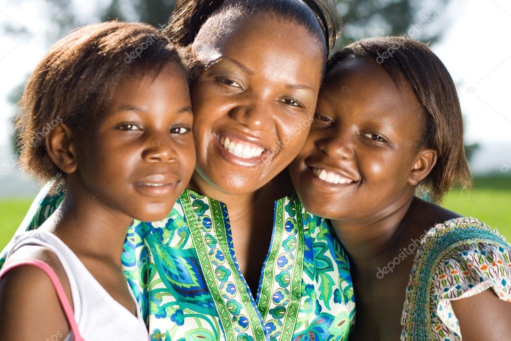 Happy african mother and daughters closeup portrait