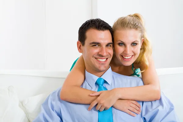 Young lovely couple sitting on sofa Stock Picture