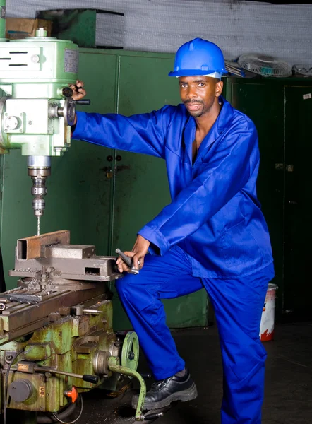 Africano machinista americano operando máquina de perfuração — Fotografia de Stock