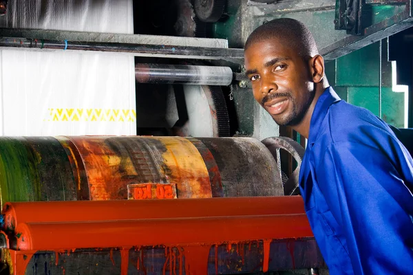 African plastic bag printing machine operator at work — Stock Photo, Image