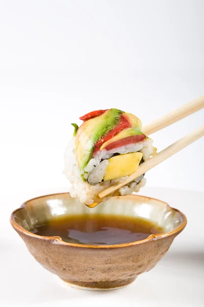 Dipping sushi rolls in venegar — Stock Photo, Image