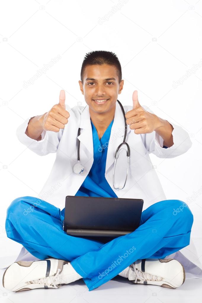Cheerful indian medical intern giving thumbs up