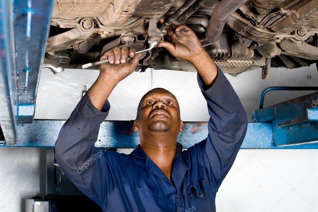 African american mechanic working on a broken down vehicle