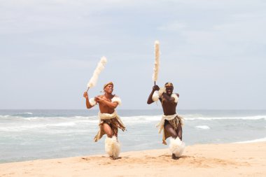 African zulu man dancing on beach clipart
