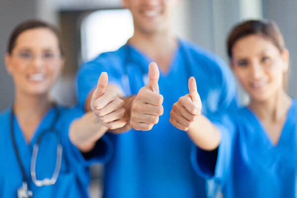 Group of healthcare workers thumbs up