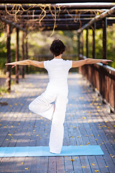 Rear view of middle aged woman yoga pose — Stock Photo, Image