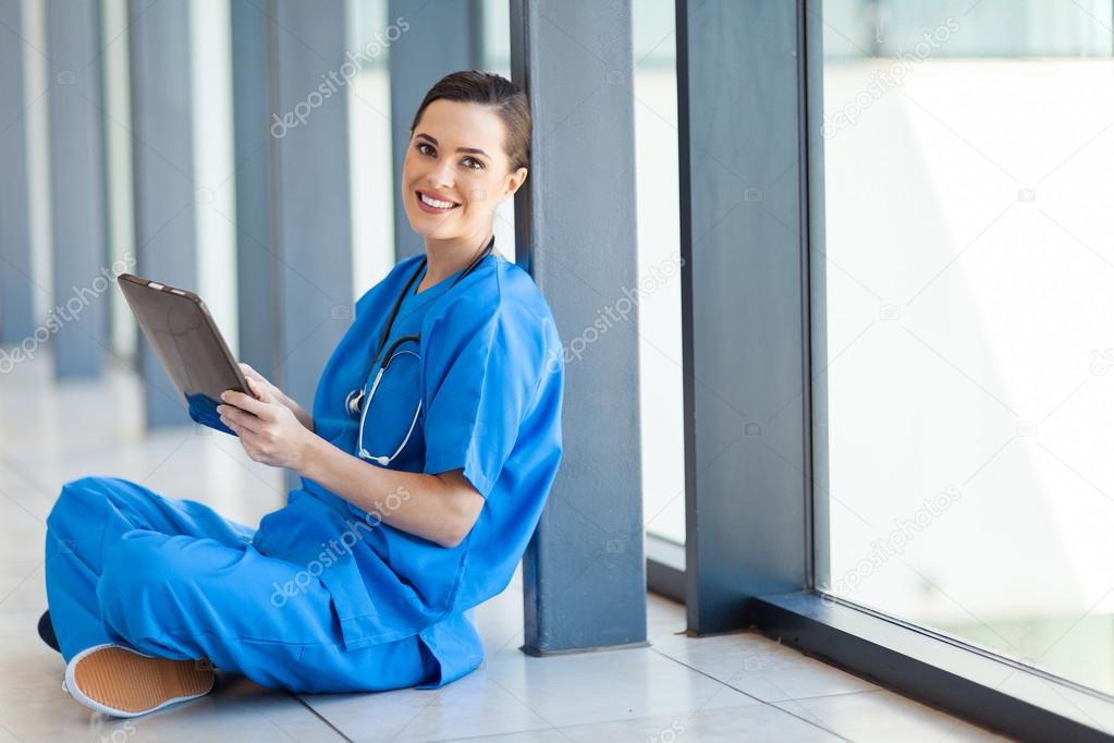 Happy healthcare worker using tablet computer