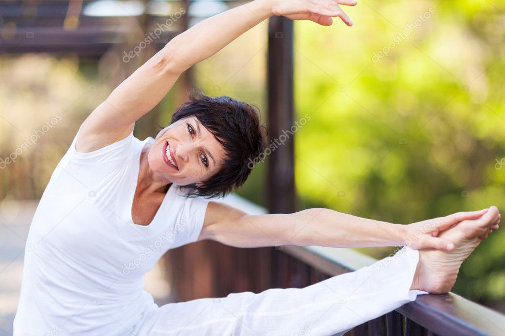 Active middle aged woman stretching