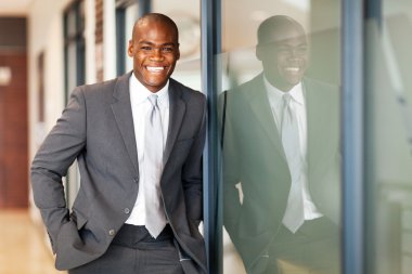 Happy african american business executive portrait in office clipart