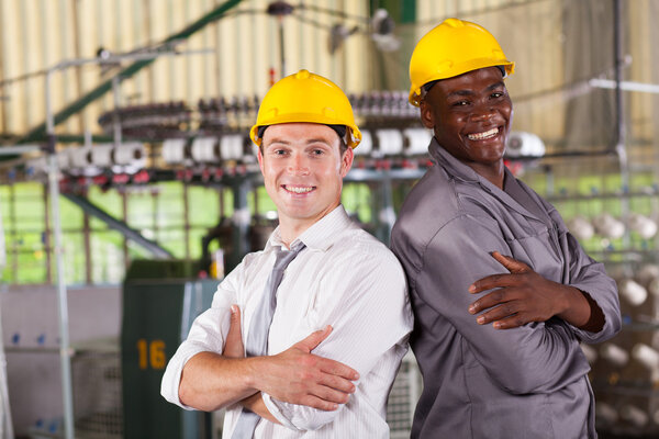 Happy factory manager and worker portrait