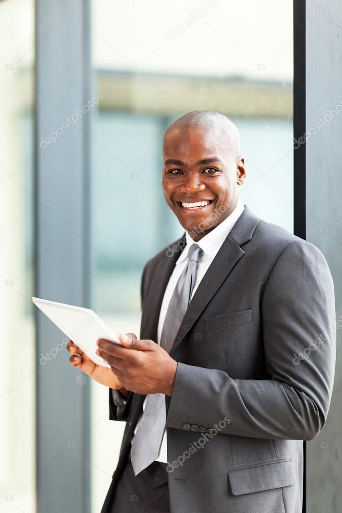 Happy african american entrepreneur using tablet computer