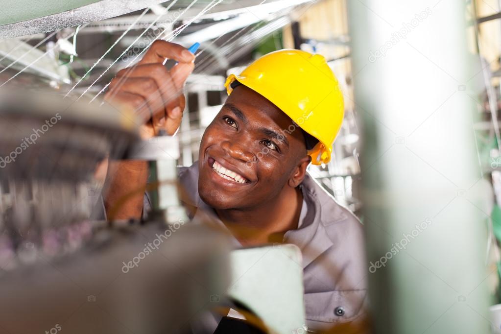 African american textile industrial quality controller at work