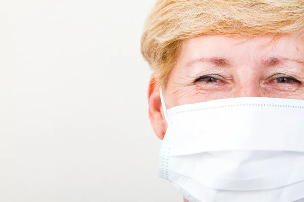 Closeup of senior female doctor with mask — Stock Photo, Image