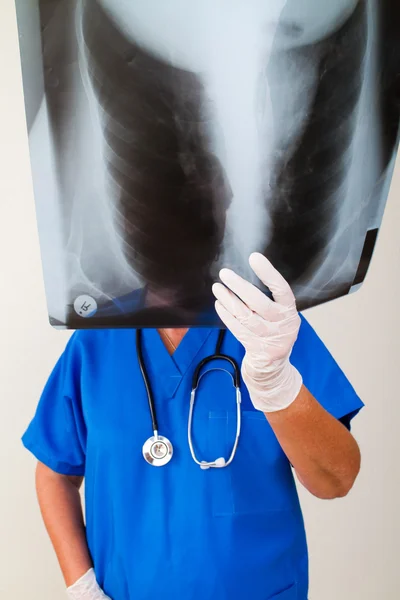 Senior doctor looking at patient's x-ray — Stock Photo, Image