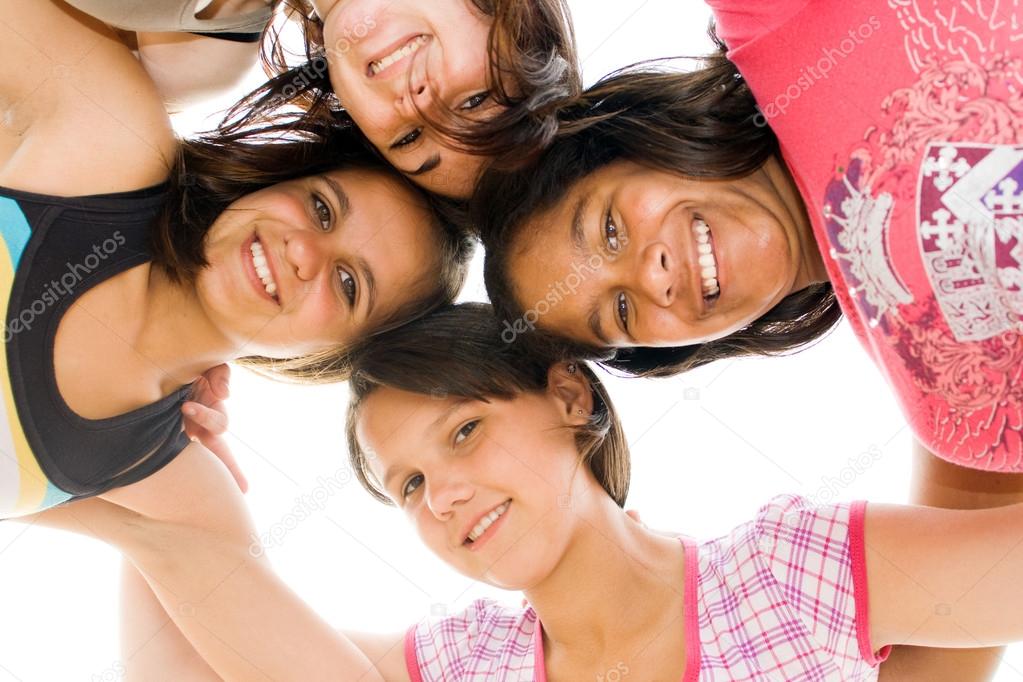 Group of teen girls looking down at camera