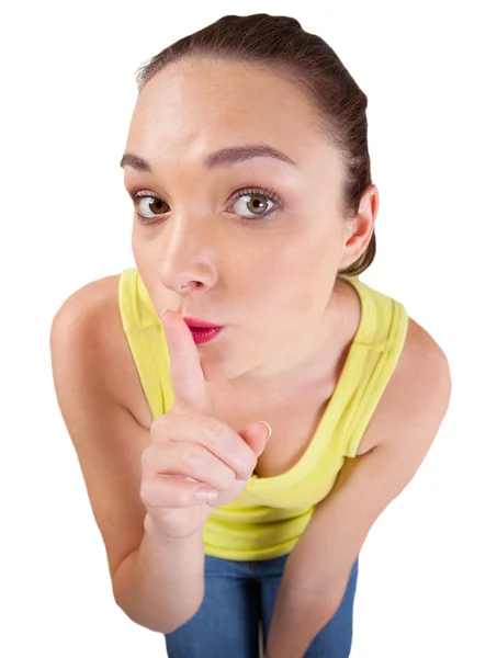 Young woman making shh gesture by putting one finger on her mouth — Stock Photo, Image