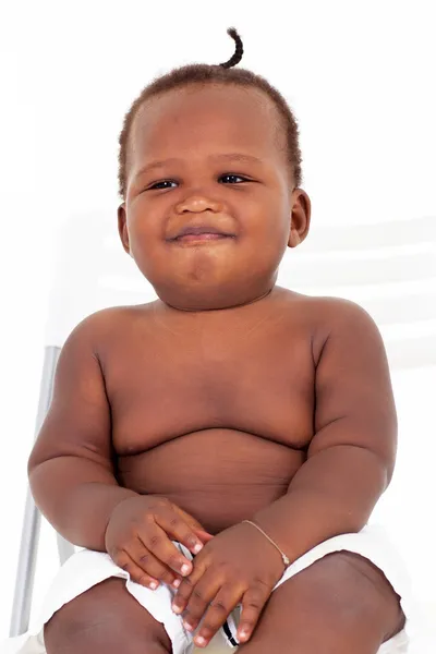 Smiling cute african american baby boy sitting on a chair — Stock Photo, Image