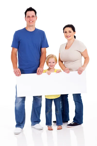 Familia joven feliz con pancarta sobre fondo blanco — Foto de Stock