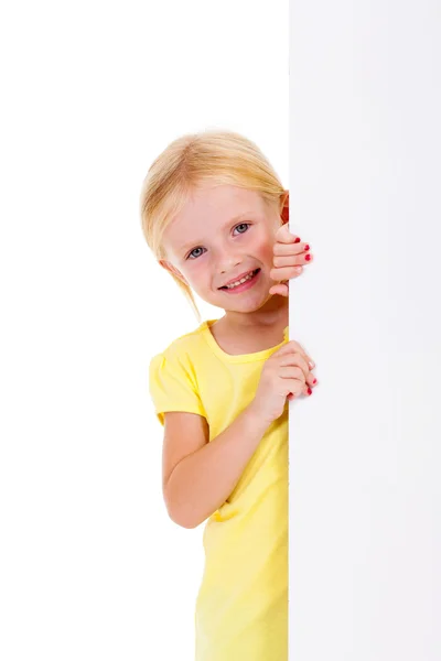 Beautiful little girl behind white board — Stock Photo, Image