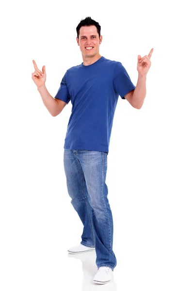 Casual young man pointing on white background — Stock Photo, Image