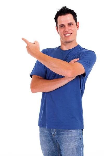 Casual young man pointing at empty copyspace — Stock Photo, Image