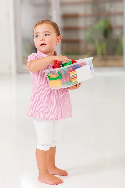 Cute little girl holding box of toy — Stock Photo, Image