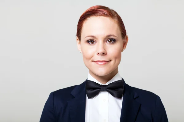 Beautiful young woman in suit with bow tie — Stock Photo, Image
