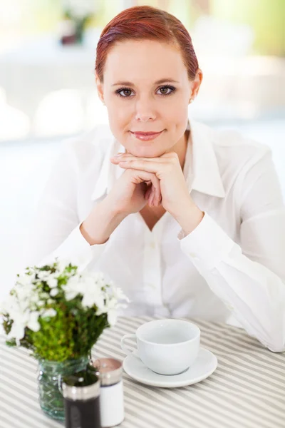 Ganska ung kvinna med kopp kaffe i caféet — Stockfoto