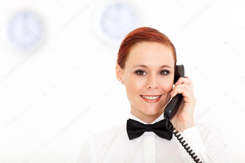 Pretty young receptionist working at hotel reception
