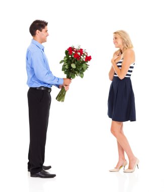 Young man giving bunch of roses to a girl on valentine's day