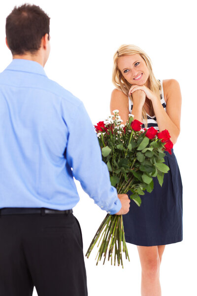 Happy woman receiving roses from a young man