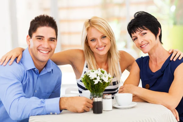 Gelukkig jonge man met vrouw en schoonmoeder in café — Stockfoto