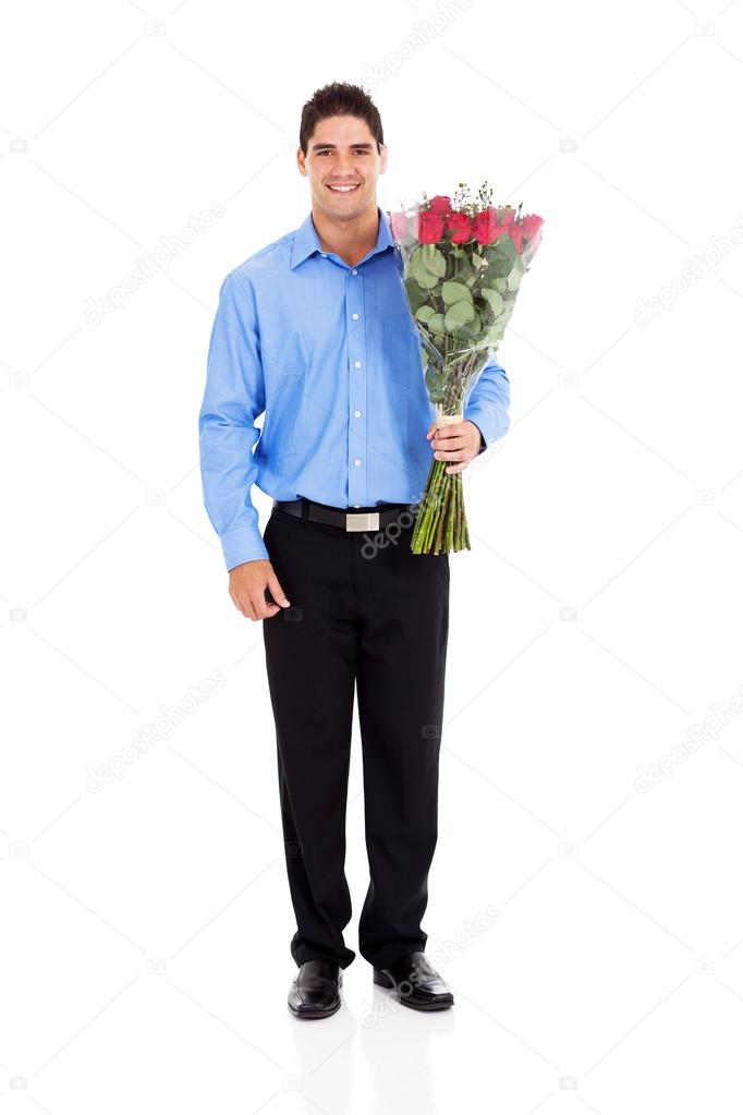 Young man holding bunch of roses isolated on white