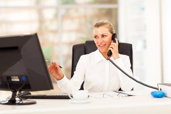 Happy middle aged businesswoman working in office — Stock Photo, Image