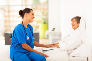 Friendly nurse visiting recovering senior patient clipart