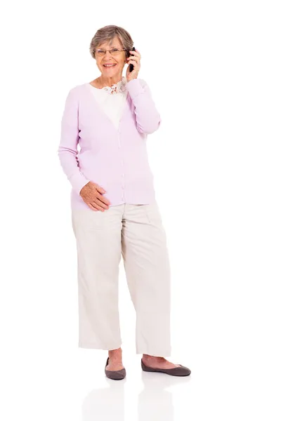 Happy elderly woman talking on mobile phone isolated on white — Stock Photo, Image