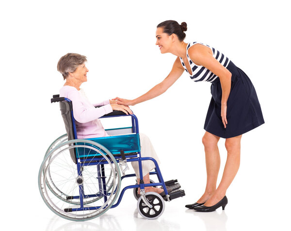 Caring adult daughter talking to senior mother isolated on white