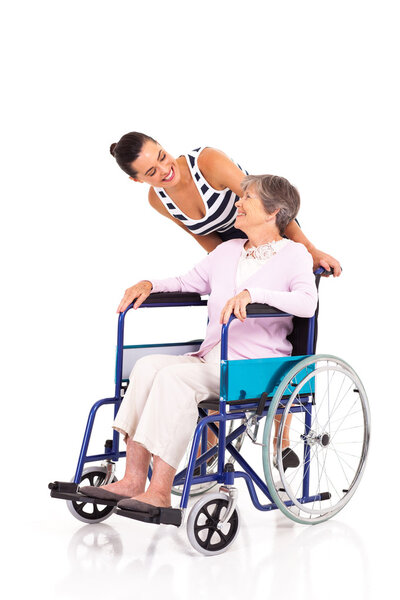 Caring daughter talking to disabled senior mother isolated on white