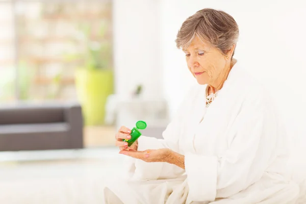 Mujer mayor tomando pastillas en casa — Foto de Stock