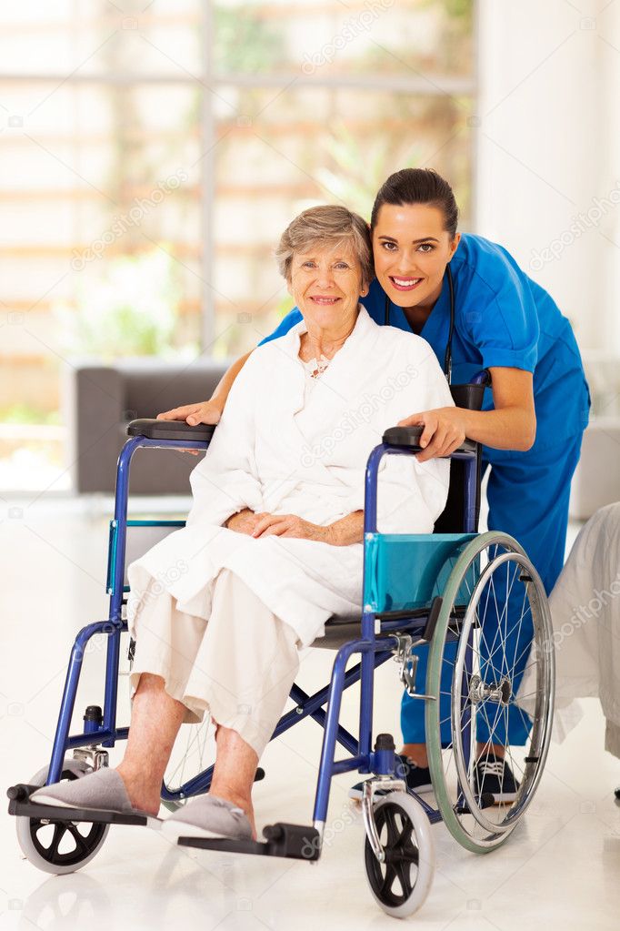 Elderly woman and young caregiver at home