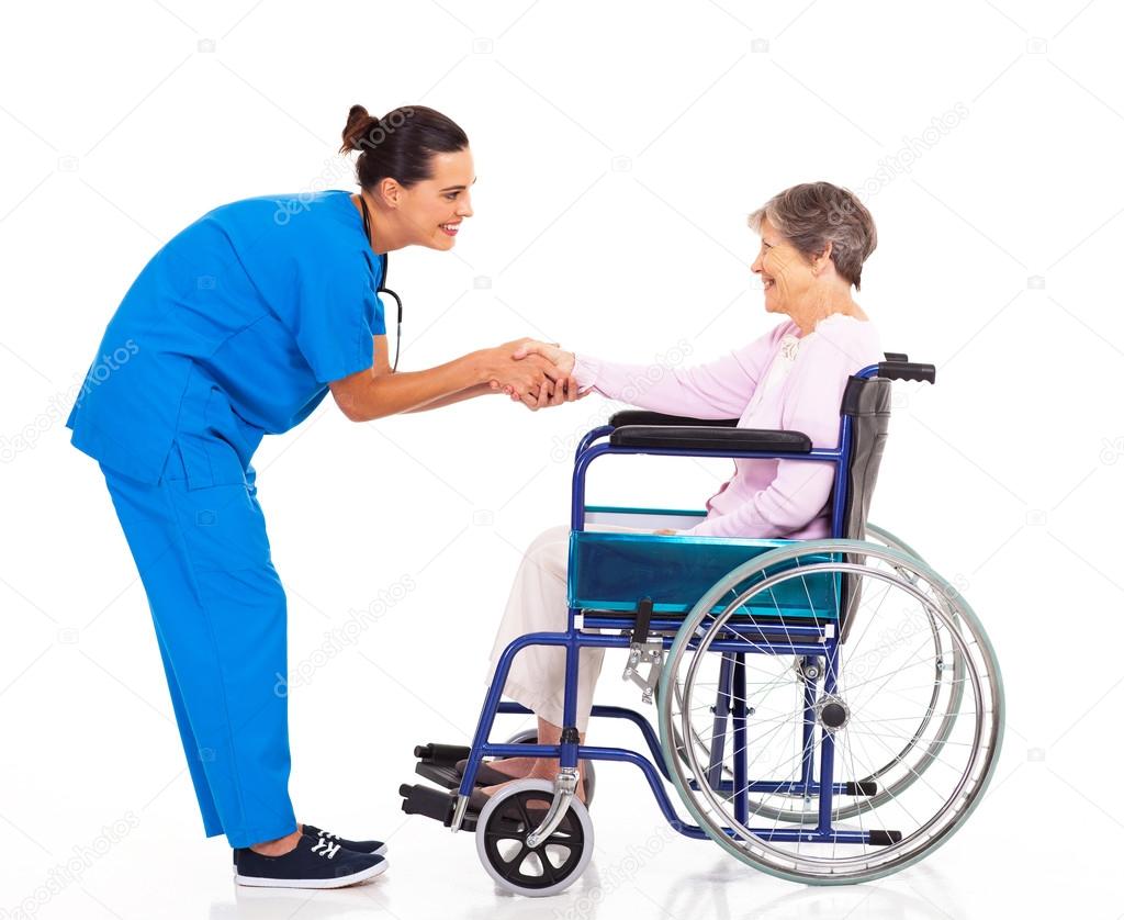 Friendly nurse greeting disabled senior patient