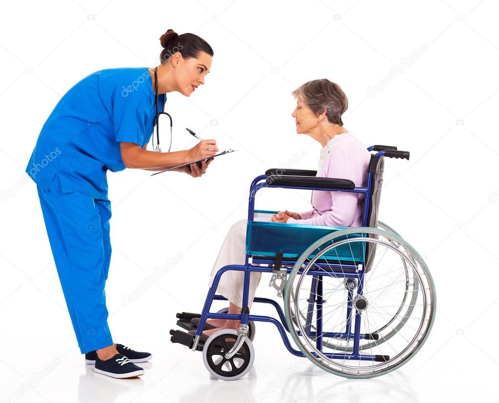 Caring nurse helping senior patient filling medical form