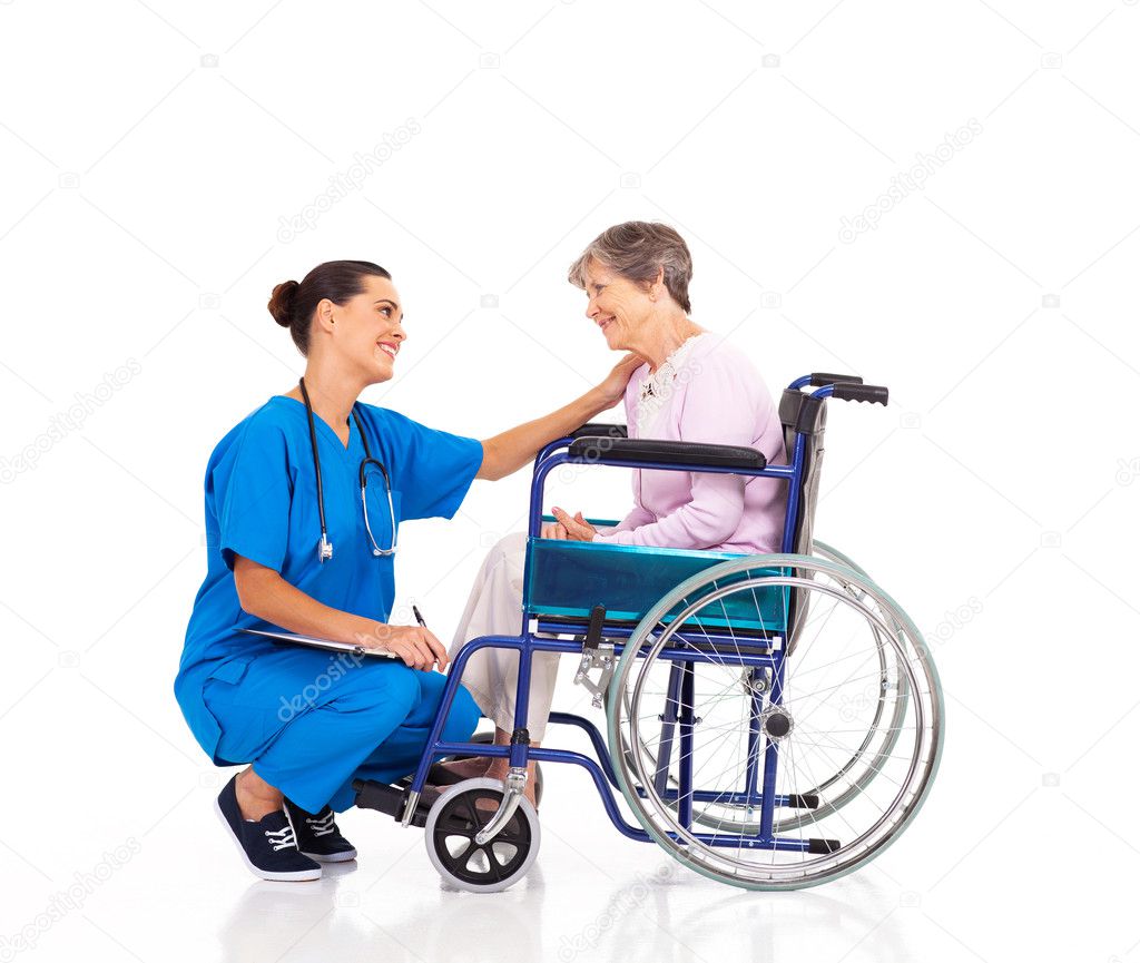 Friendly nurse talking to disabled senior patient