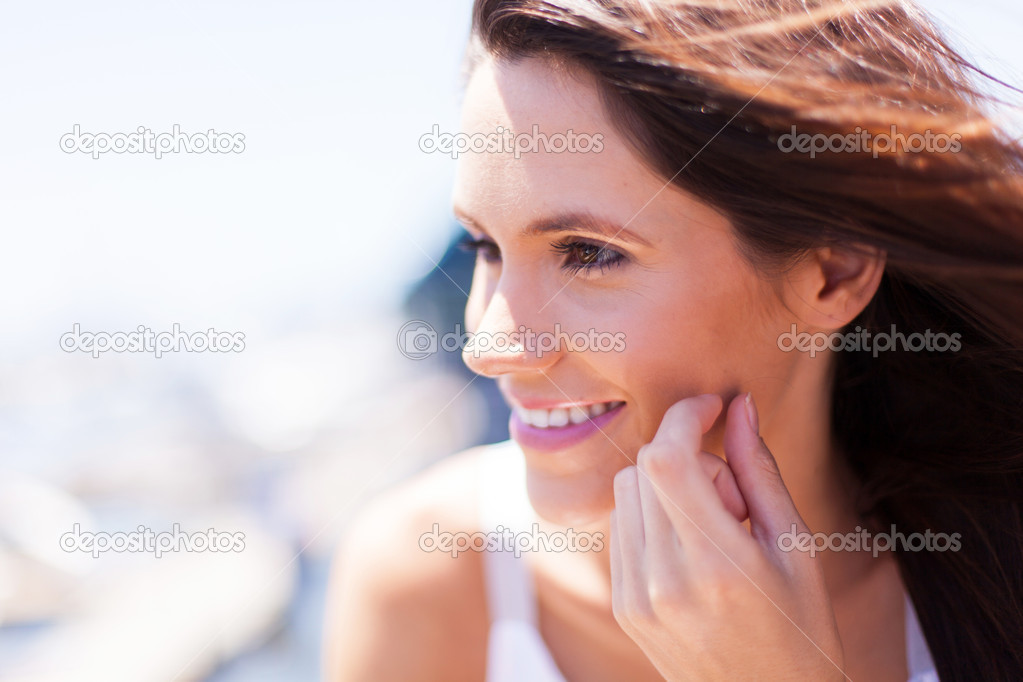Happy young woman face closeup outdoors