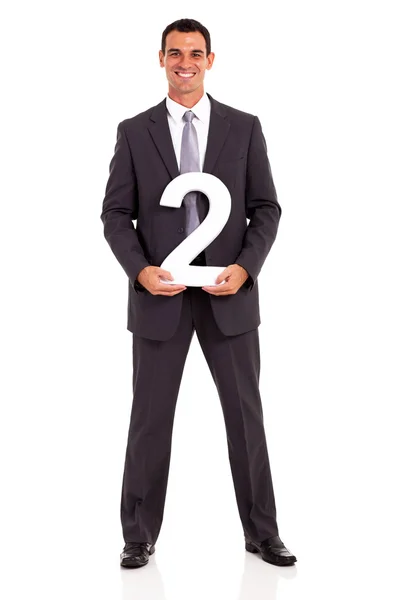 Young businessman holding number 2 isolated on white — Stock Photo, Image