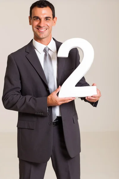Handsome businessman holding number 2 — Stock Photo, Image